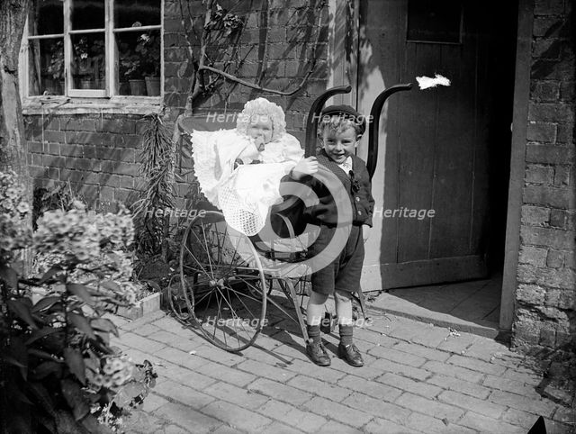 Child with a baby in a pram, Hellidon, Northamptonshire, 1900. Artist: A Newton