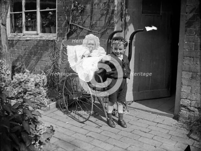 Child with a baby in a pram, Hellidon, Northamptonshire, 1900. Artist: A Newton