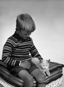 Child with a cat, 1963. Creator: Michael Walters