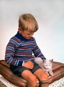 Child with a cat, 1963. Creator: Michael Walters