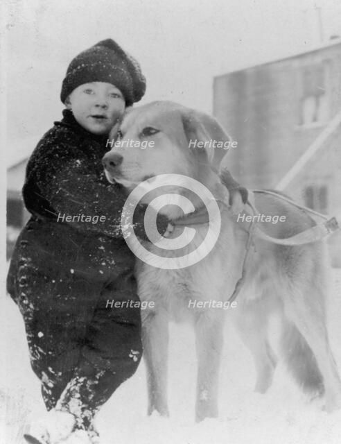 Child with dog, between c1900 and c1930. Creator: Unknown.