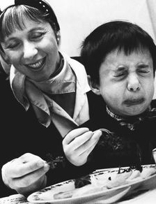 Child tasting bitter herbs at Passover, 1992. Creator: John Nathan