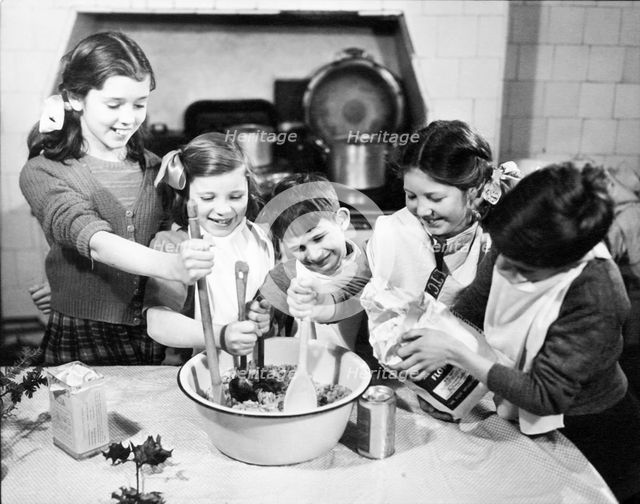 Children cooking at Christmas, c1955. Creator: Arthur Charles Kirby Ware.