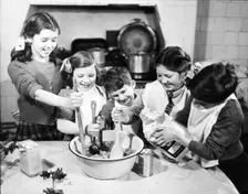 Children cooking at Christmas, c1955. Creator: Arthur Charles Kirby Ware