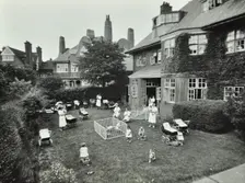 Children and carers in a garden, Hampstead, London, 1960