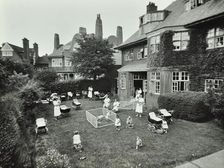 Children and carers in a garden, Hampstead, London, 1960