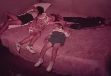 Children asleep on bed during square dance, McIntosh County, Okla., 1939 or 1940. Creator: Russell Lee