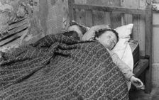 Children asleep in a slum dwelling in London's East End, 1965. Creator: Unknown