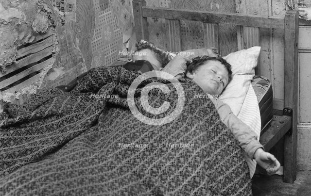 Children asleep in a slum dwelling in London's East End, 1965.  Creator: Unknown.