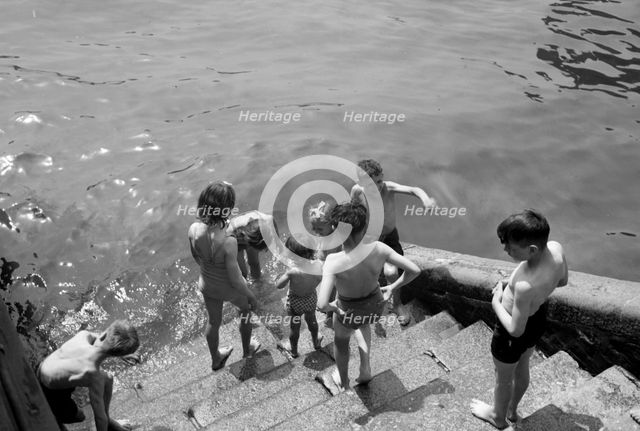 Children bathing in the River Thames, Tower Pier approach, Stepney, London, c1945-c1965. Artist: SW Rawlings