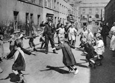 Children dancing in the street, London, 1926-1927