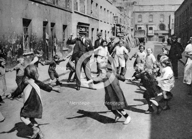 Children dancing in the street, London, 1926-1927. Artist: Unknown