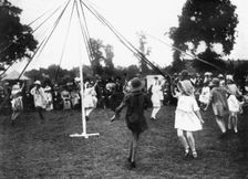 Children dancing round a maypole, 1926