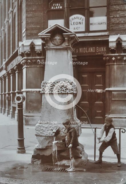 Children drawing water from the Aldgate pump, London, August 1908. Artist: Unknown.