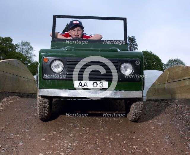 Children driving a toy Land Rover. Artist: Unknown.