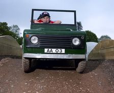 Children driving a toy Land Rover
