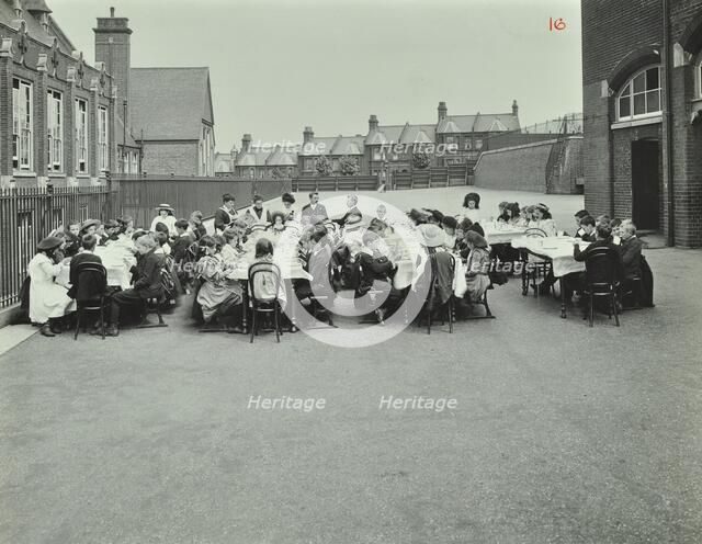 Children eating dinner at tables in the playground, Shrewsbury House Open Air School, London, 1908. Artist: Unknown.