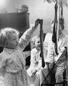 Children hanging up Christmas stockings, c1955. Creator: Arthur Charles Kirby Ware