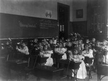 Children in a classroom blowing pinwheels in a Washington, D.C., grade school, (1899?). Creator: Frances Benjamin Johnston