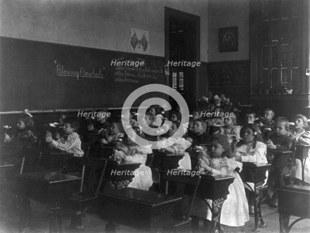 Children in a classroom blowing pinwheels in a Washington, D.C., grade school, (1899?). Creator: Frances Benjamin Johnston.