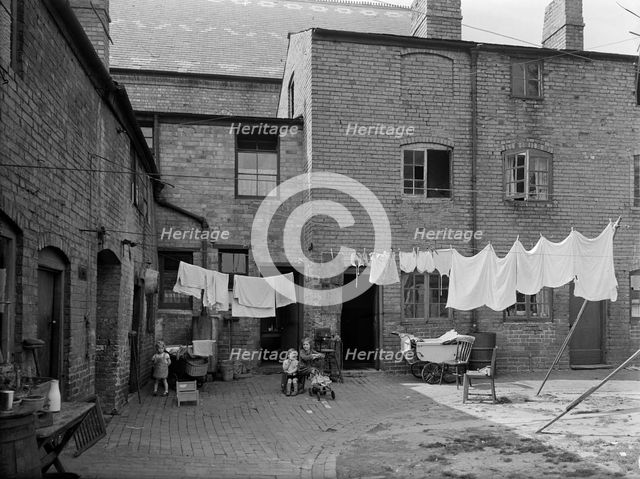 Children in a run-down courtyard, Warwickshire, 1946. Artist: Unknown