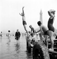 Children in swimming costumes jump into the sea, Blackpool, c1946-c1955. Artist: John Gay