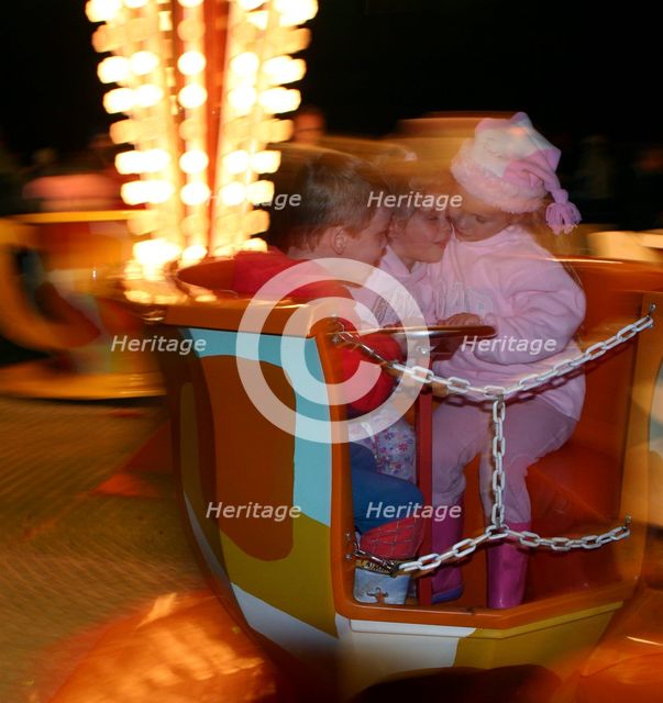 Children on a fairground ride, 2005.  Creator: Peter Thompson.