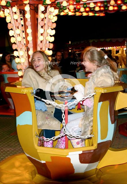 Children on a fairground ride, 2005.  Creator: Peter Thompson.