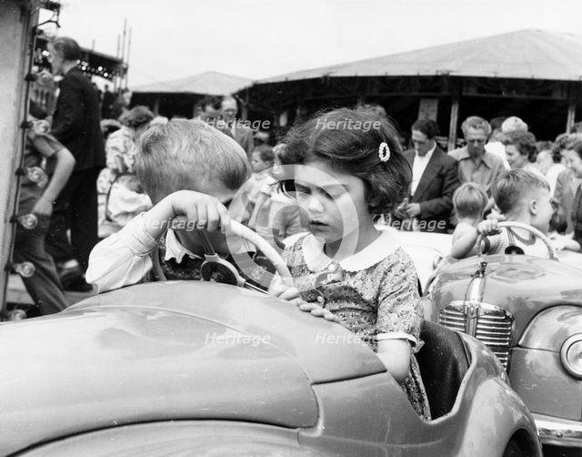 Children on a ride at Hampstead funfair, London, c1950. Creator: Henry Grant.