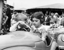Children on a ride at Hampstead funfair, London, c1950. Creator: Henry Grant