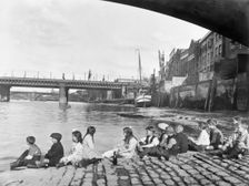 Children on the cobbled causeway under Southwark Bridge, London, c1930. Creator: George Davison Reid