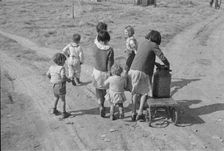 Children of migratory workers, hauling water, American River camp, San Joaquin Valley, CA, 1936. Creator: Dorothea Lange