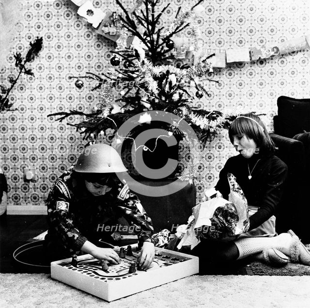 Children opening Christmas presents in their London home, c1960s. Creator: Henry Grant.