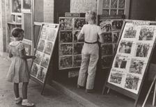 Children looking at posters in front of movie, Saturday, Steele, Missouri, 1938-08. Creator: Russell Lee