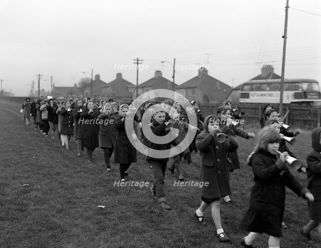 Children marching with home made bugles, Middlesborough, Teesside,1964.  Creator: Michael Walters.