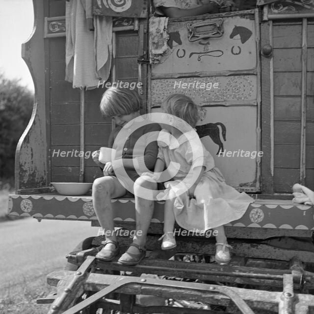 Children sitting on the steps of a gipsy caravan, Outwood, Surrey, 1963.