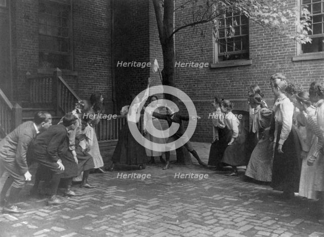 Children playing game with handkerchief on stick in school yard, Washington, D.C., (1899?). Creator: Frances Benjamin Johnston.