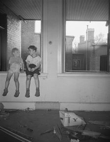 Children playing in wrecked houses along Independence Avenue, Washington, D.C, 1942. Creator: Gordon Parks