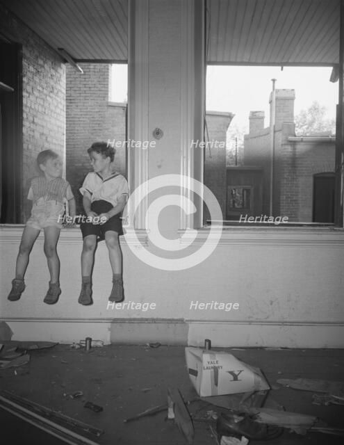 Children playing in wrecked houses along Independence Avenue, Washington, D.C, 1942. Creator: Gordon Parks.