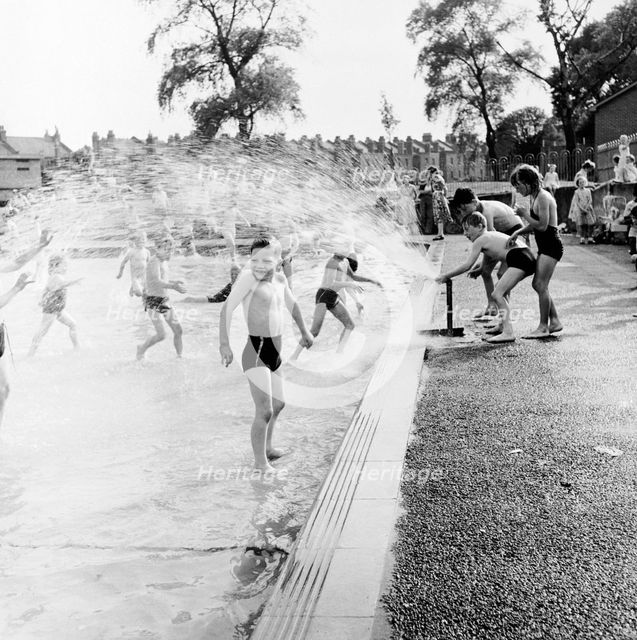 Children playing in a London paddling pool, c1950s. Creator: Henry Grant.