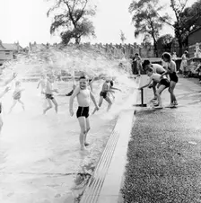 Children playing in a London paddling pool, c1950s. Creator: Henry Grant