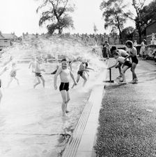 Children playing in a London paddling pool, c1950s. Creator: Henry Grant