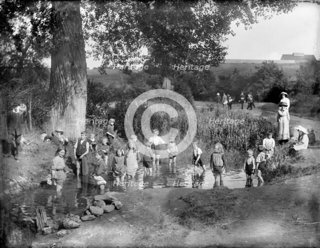 Children playing in a pool on a hot summer's day, Cowley, Oxford, Oxfordshire, 1914.  Artist: Henry Taunt