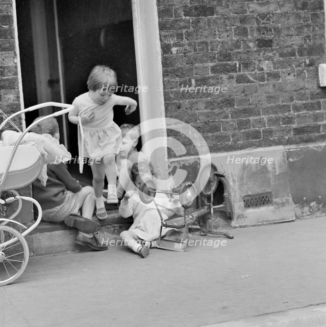 Children playing on a doorstep, London, 1960-1965. Artist: John Gay