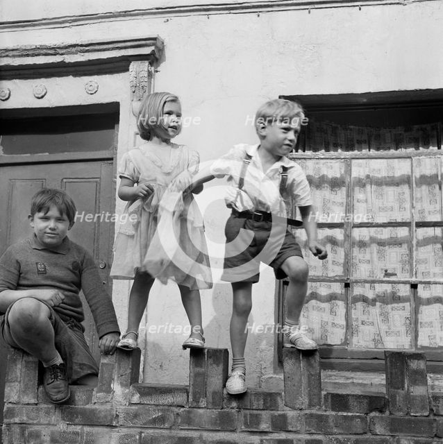 Children playing on a wall, London, 1960-1965. Artist: John Gay