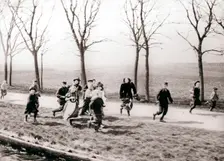 Children running alongside a canal, Monnickendam, Netherlands, 1898.Artist: James Batkin