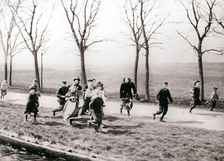 Children running alongside a canal, Monnickendam, Netherlands, 1898.Artist: James Batkin