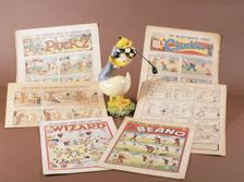 Children's comics with golfing theme, and Donald Duck figurine, c1950s-1960s. Creator: Unknown
