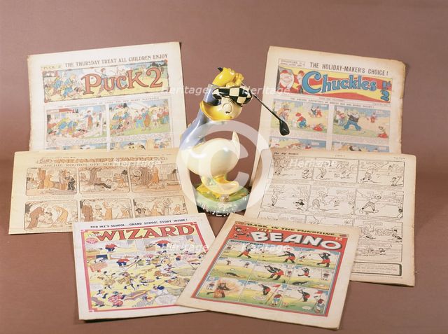 Children's comics with golfing theme, and Donald Duck figurine, c1950s-1960s. Creator: Unknown.