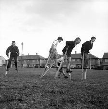 Children walking on stilts, c1955. Creator: Arthur Charles Kirby Ware
